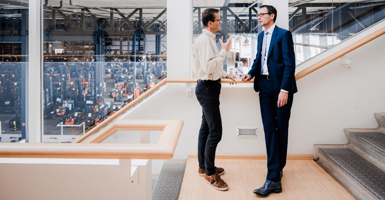 Vertriebsmitarbeiter die sich am Gang unterhalten